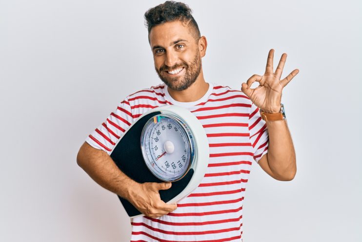 Handsome,Man,With,Beard,Holding,Weight,Machine,To,Balance,Weight