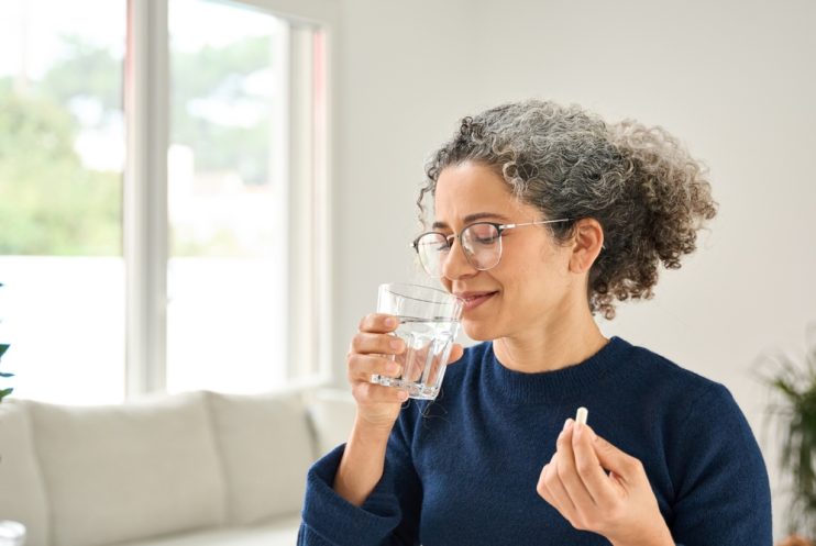 Happy,Healthy,Woman,Of,Middle,Age,Talking,Pill,Holding,Glass Happy,Healthy,Woman,Of,Middle,Age,Talking,Pill,Holding,Glass