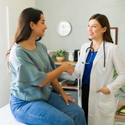 Female,Doctor,Happily,Shaking,Hands,With,Her,Hispanic,Patient,After